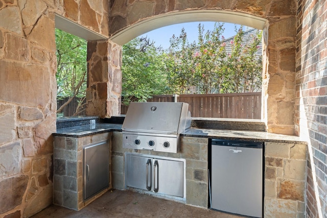 view of patio featuring a grill and an outdoor kitchen