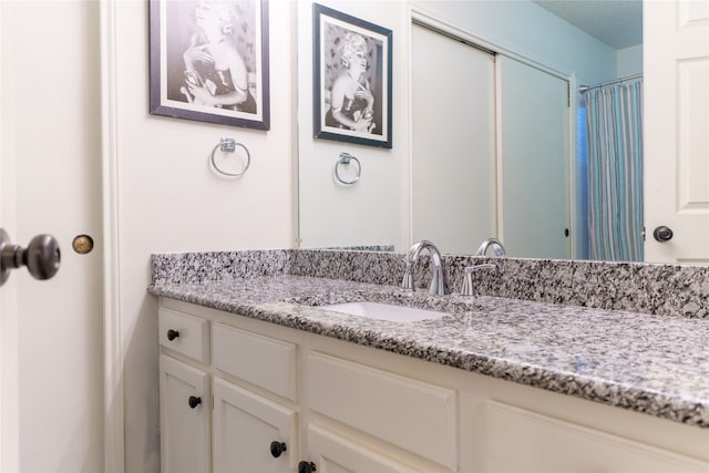 bathroom with vanity and walk in shower