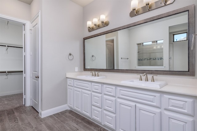 bathroom featuring vanity and a shower