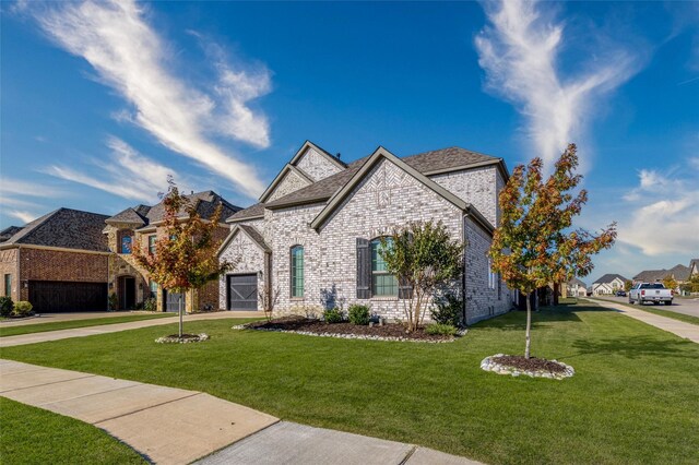 view of front of property featuring a front yard and a garage