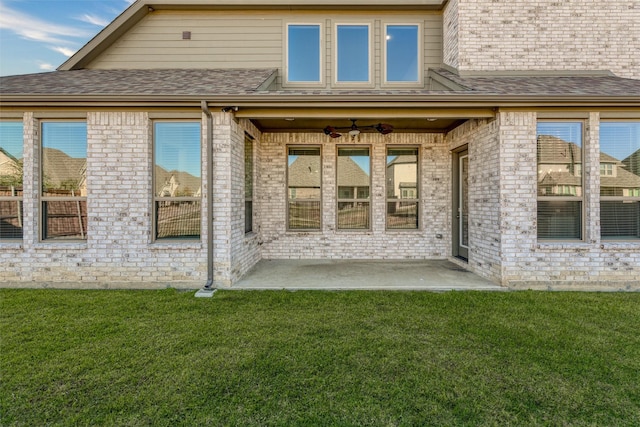 rear view of house with a lawn, ceiling fan, and a patio area