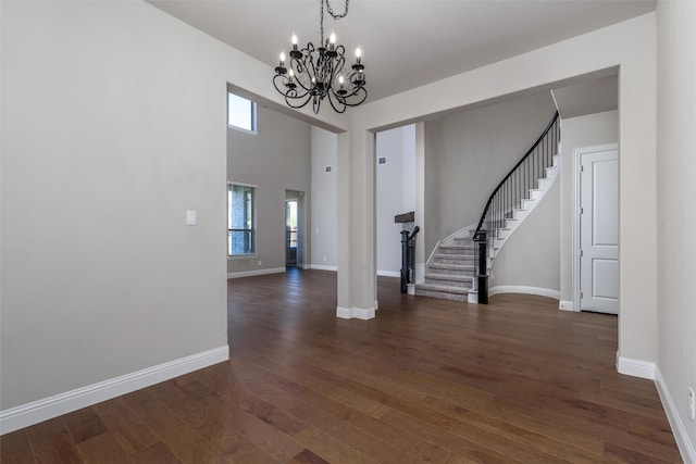 interior space with dark hardwood / wood-style floors and an inviting chandelier