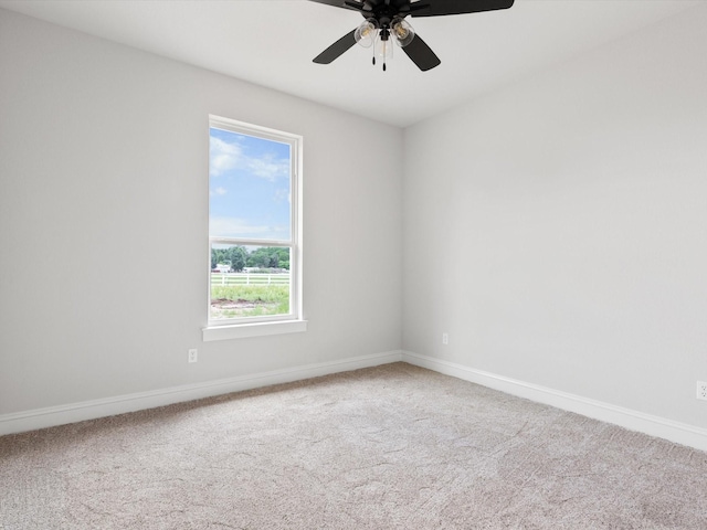 empty room with carpet flooring and ceiling fan