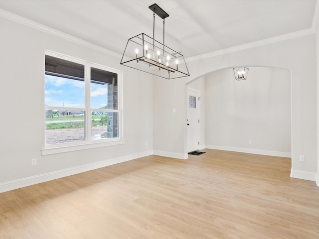 empty room featuring light wood-type flooring and ornamental molding