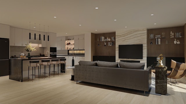 living room with sink and light hardwood / wood-style floors