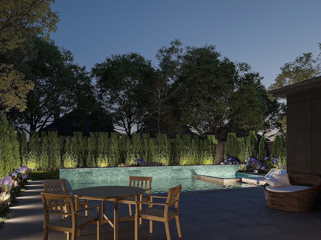 pool at dusk with a patio