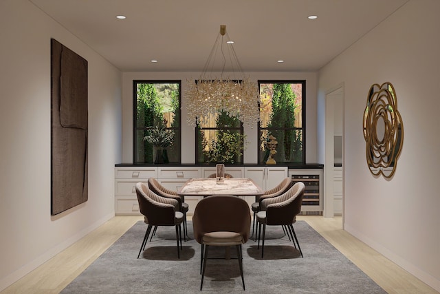 dining area with light hardwood / wood-style floors, plenty of natural light, and beverage cooler