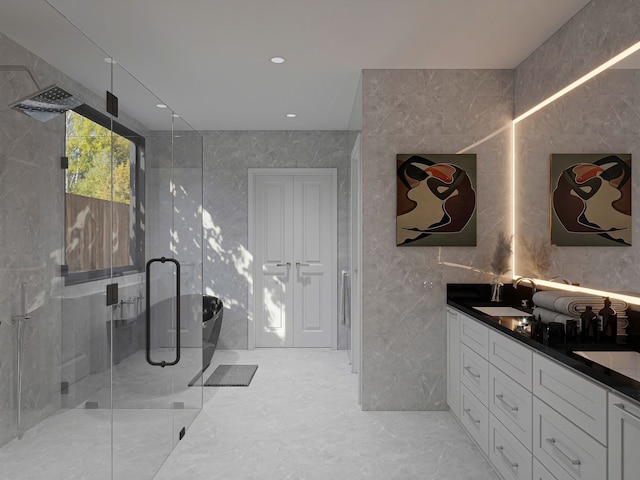 bathroom featuring vanity, an enclosed shower, and tile walls