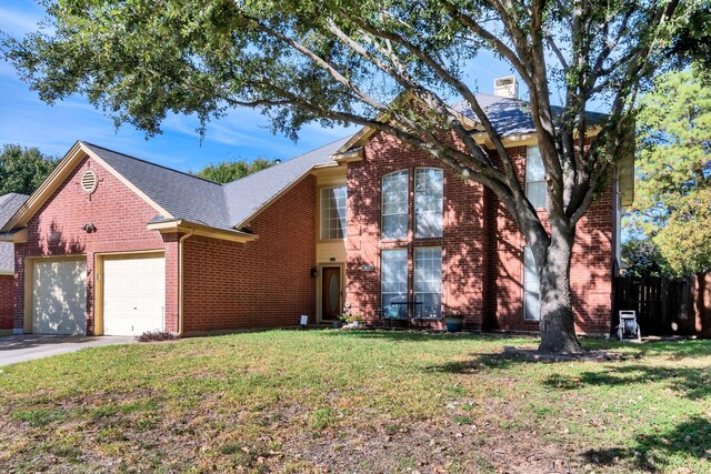 view of front of home with a garage and a front lawn