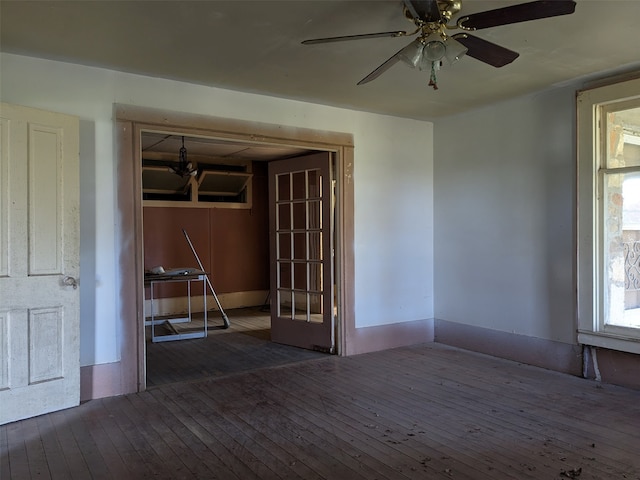 spare room with ceiling fan and dark wood-type flooring