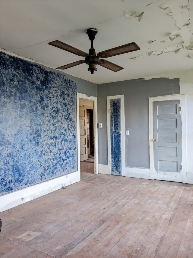 empty room with wood-type flooring and ceiling fan