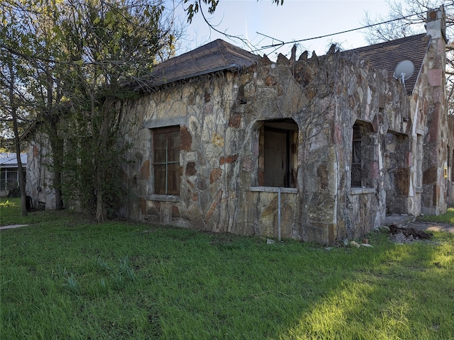 view of home's exterior with a yard