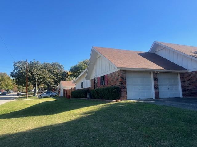 view of property exterior featuring a yard and a garage