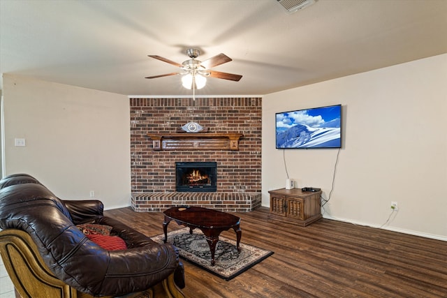 living room with hardwood / wood-style floors, ceiling fan, and a fireplace