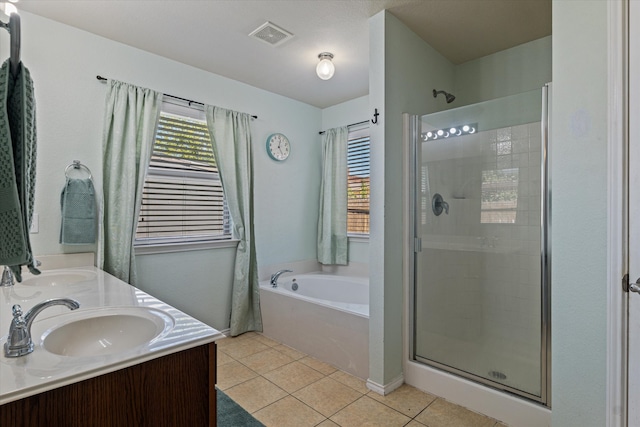 bathroom featuring vanity, tile patterned flooring, and plus walk in shower