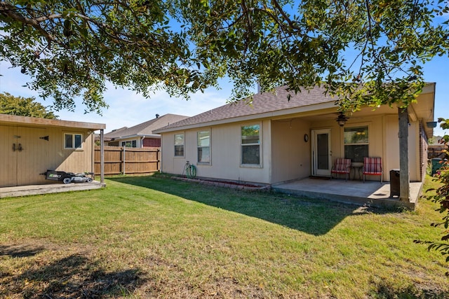 back of house featuring a yard and a patio