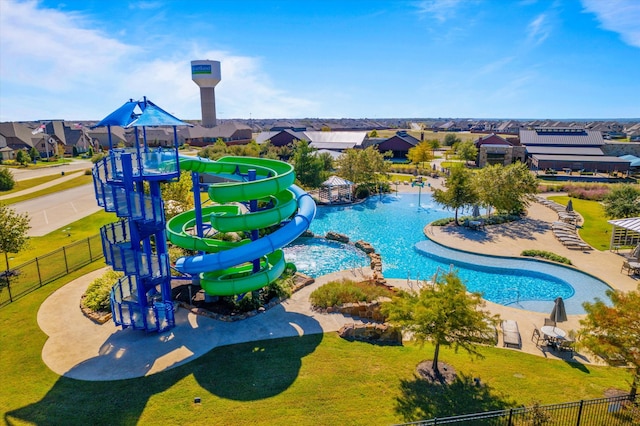 view of pool featuring a playground and a lawn