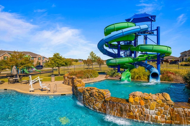 view of pool featuring a patio area and a water slide