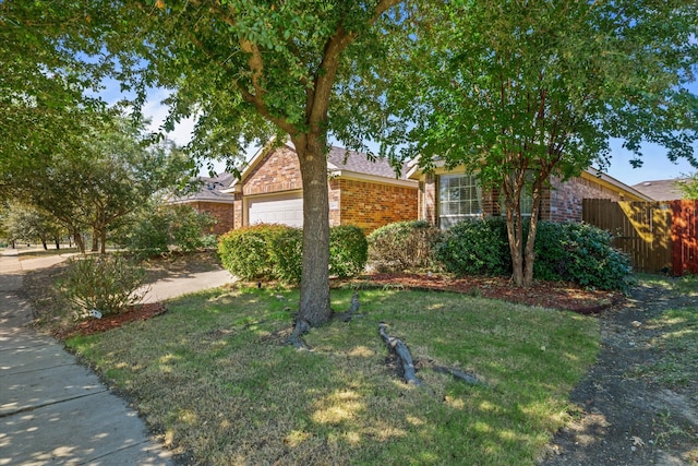 view of front facade featuring a front yard and a garage