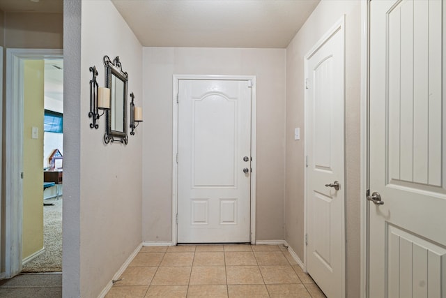 doorway to outside with light tile patterned flooring