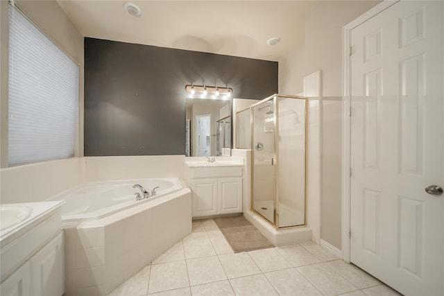 bathroom featuring tile patterned flooring, vanity, and plus walk in shower