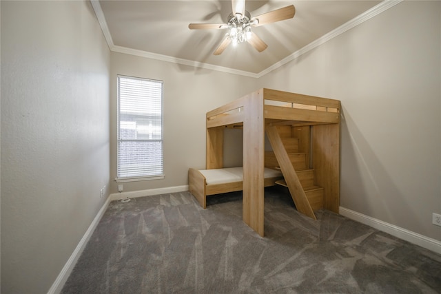 unfurnished bedroom featuring dark carpet, ceiling fan, and crown molding