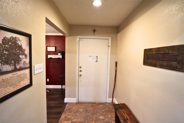 corridor featuring a textured ceiling