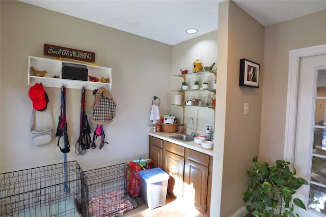 interior space with sink and a textured ceiling