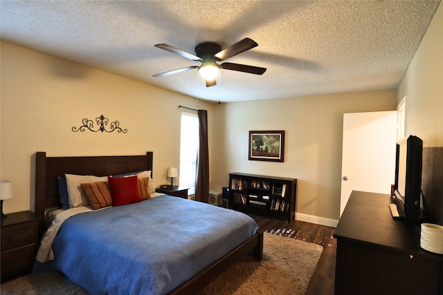 bedroom featuring ceiling fan, dark hardwood / wood-style floors, and a textured ceiling