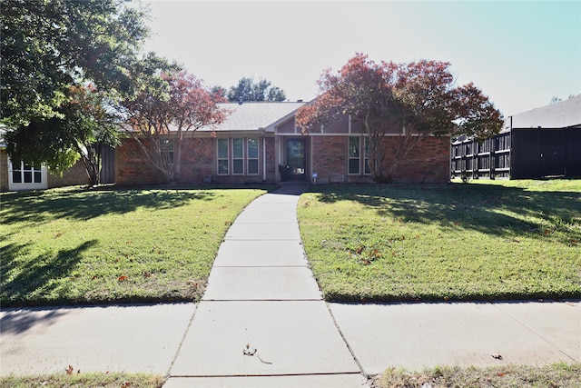 single story home featuring a front lawn