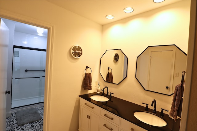 bathroom featuring vanity and a shower with door