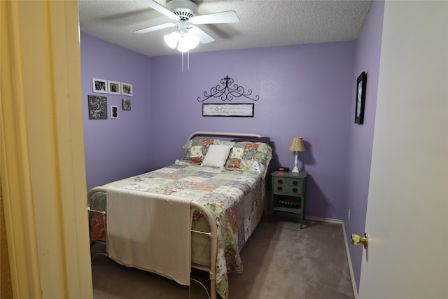 bedroom with ceiling fan, a textured ceiling, and dark colored carpet