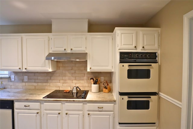 kitchen with tasteful backsplash, black electric stovetop, dishwashing machine, white cabinets, and double oven