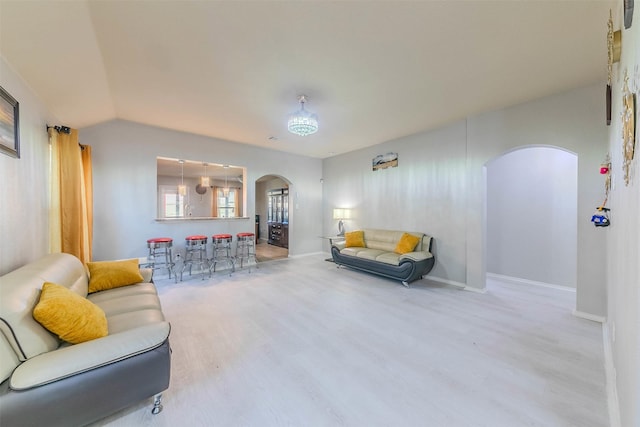 living room featuring wood-type flooring and lofted ceiling