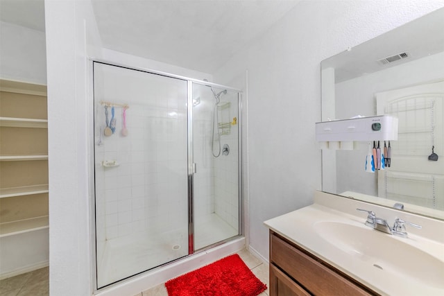 bathroom featuring tile patterned floors, vanity, and walk in shower