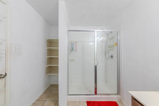 bathroom with tile patterned flooring, vanity, and an enclosed shower