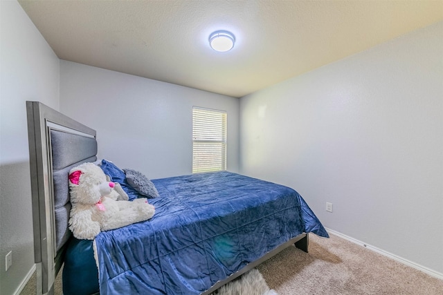 carpeted bedroom featuring a textured ceiling