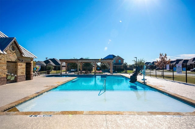 view of swimming pool with a pergola and a patio