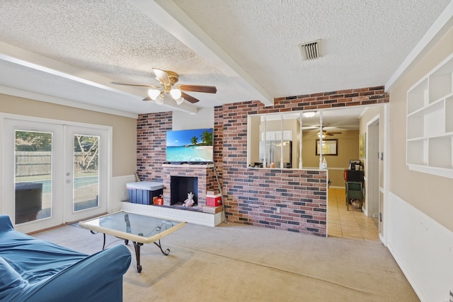 living room with ceiling fan, light colored carpet, a textured ceiling, and french doors