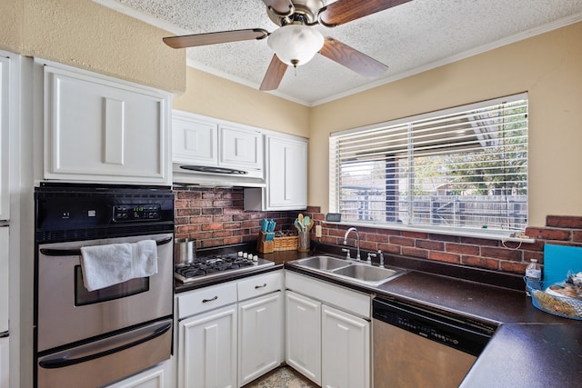 kitchen featuring sink, decorative backsplash, ornamental molding, appliances with stainless steel finishes, and white cabinetry