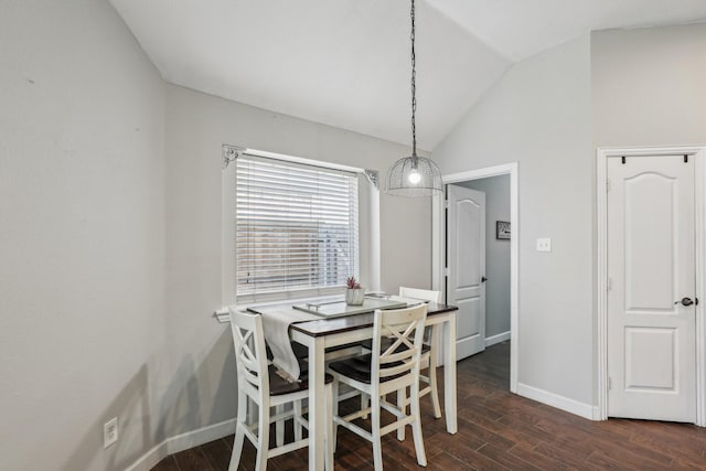 dining area with vaulted ceiling, baseboards, and dark wood finished floors