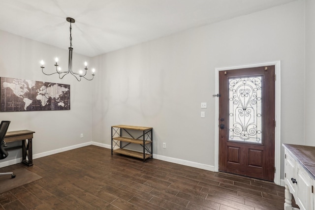 foyer with baseboards, dark wood finished floors, and a notable chandelier