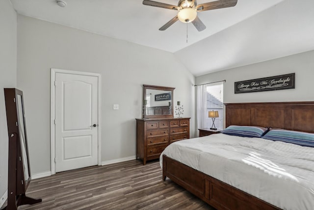 bedroom with dark wood-style floors, baseboards, vaulted ceiling, and a ceiling fan