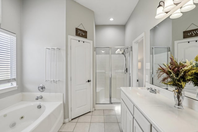 full bathroom with a tub with jets, a shower stall, vanity, and tile patterned floors