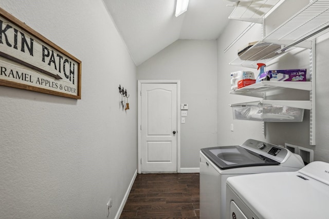 laundry area with dark wood-style floors, washer and dryer, laundry area, and baseboards