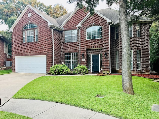 view of front facade with a garage, central AC, and a front yard