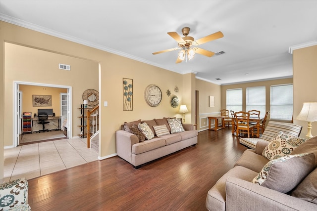 living room with hardwood / wood-style floors, ceiling fan, and crown molding