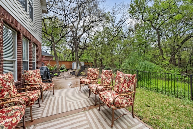 deck featuring a storage unit and a patio