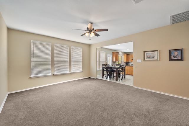 carpeted spare room featuring ceiling fan