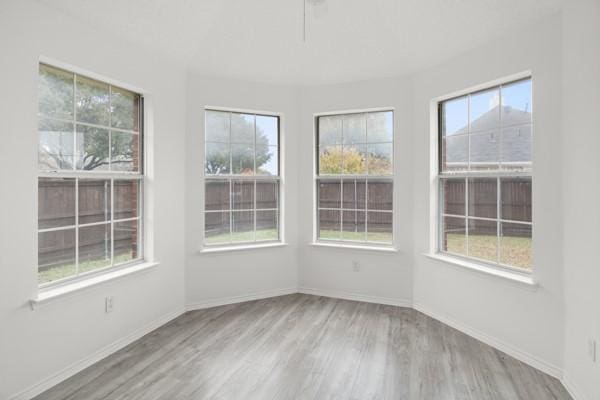 unfurnished sunroom featuring a wealth of natural light